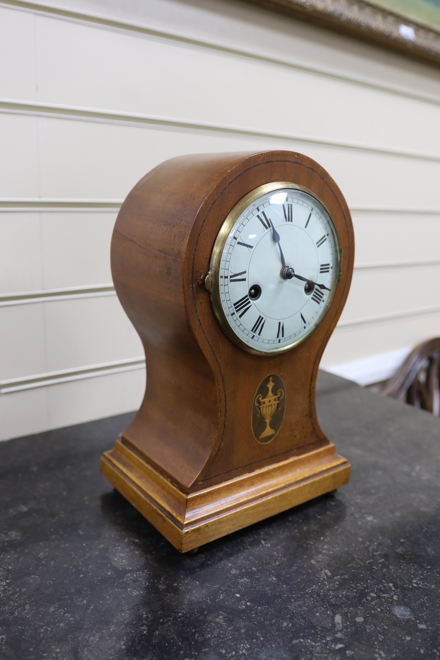 An Edwardian mahogany balloon cased mantle clock, with key, 31cm.